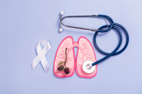 Pink lungs with lung cancer awareness ribbon and stethoscope.