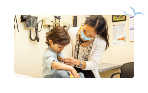 Pediatrician checking small boy's heart