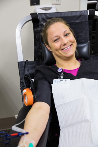 Woman smiling while donating blood.