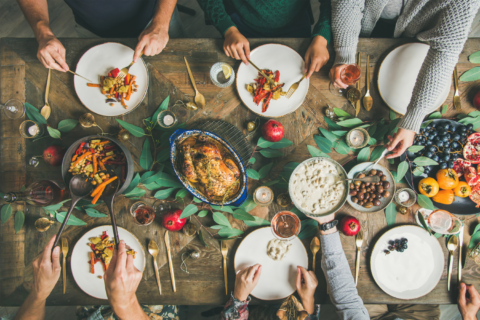People gathered around a table sharing a holiday meal.