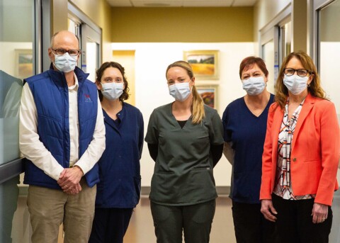 A group of five staff from Island Wound Care & Hyperbaric Medicine are smiling at camera while wearing masks.