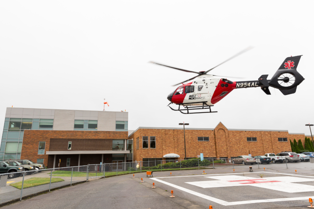 Helicopter landing on helipad in the 25th Street parking lot of Island Health.