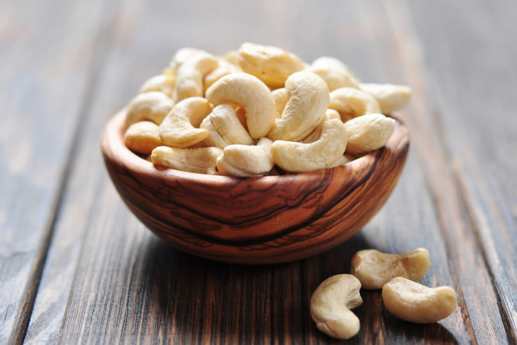 Bowl of cashews on wooden table
