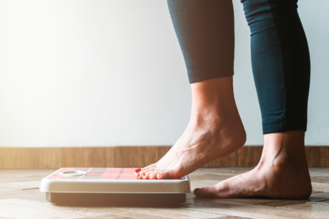 Image of a person stepping on a scale.