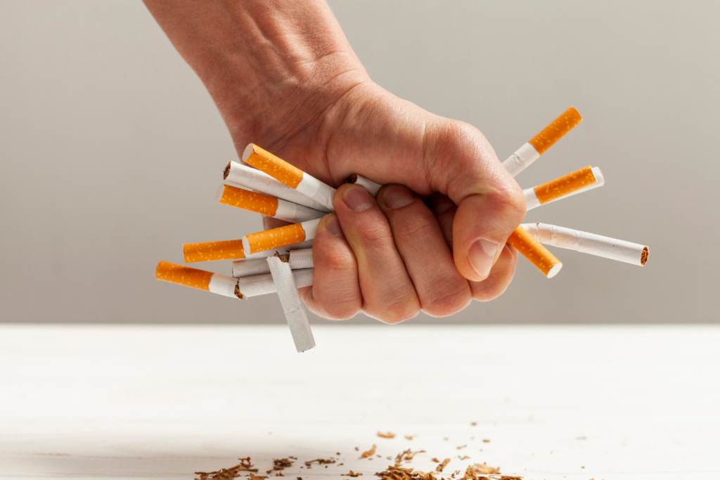 Man's hand crushing cigarettes