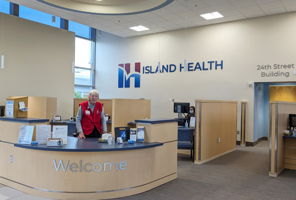 Island Health's newly remodeled main lobby, with expanded patient registration desks and a cheerful volunteer to welcome visitors.