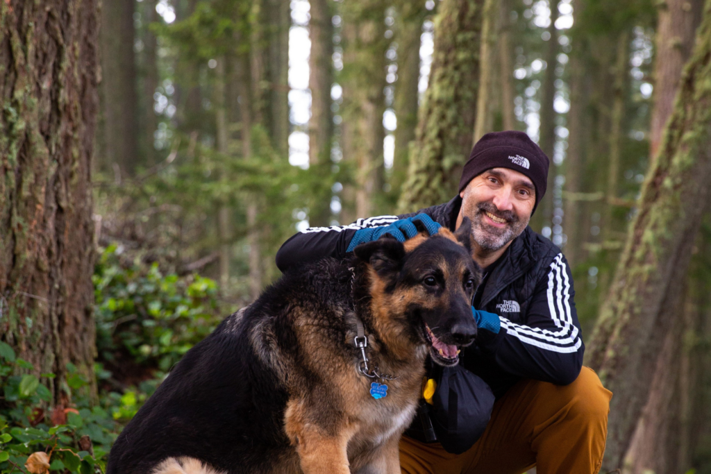 Family Medicine Provider Dr. Ali Salari in the woods with his dog.