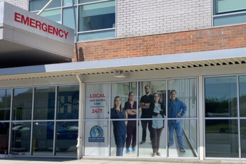 Updated Island Health emergency department entrance with graphic of staff on the window.