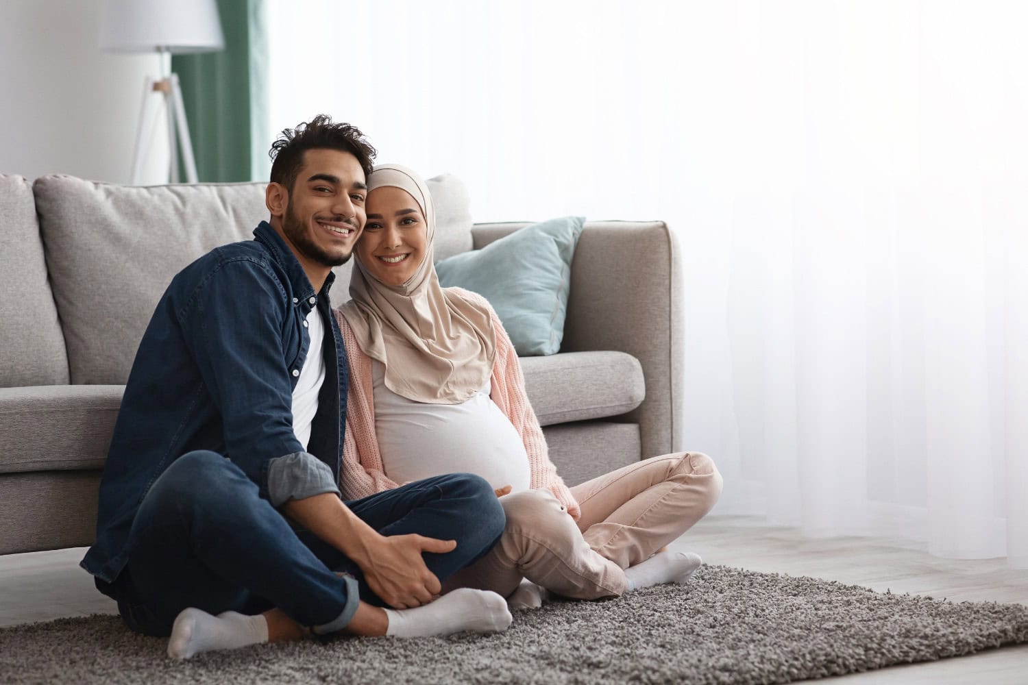 Pregnant couple sitting on floor