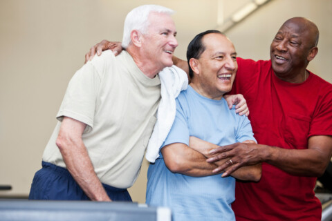 Group of three men smiling