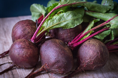 photo of purple beets on wooden table