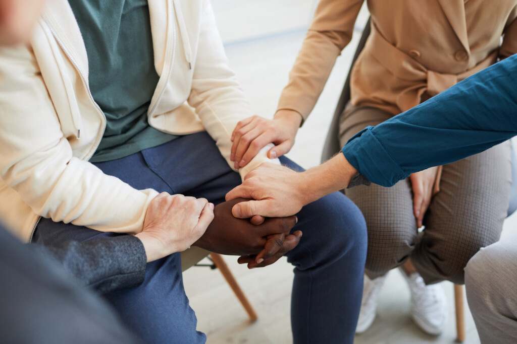 group of people holding hands at support group