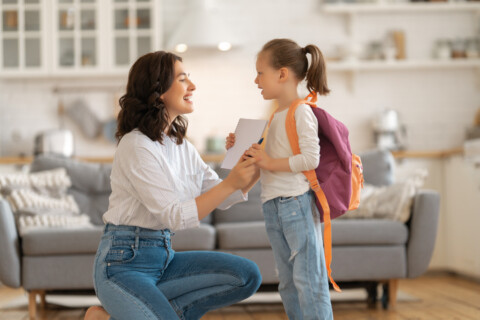A mom talking with her young daughter who is preparing to go back to school.