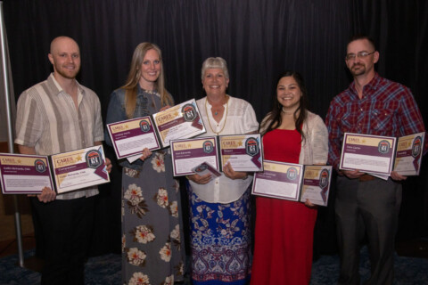 Group of CARES All-stars winners, holding their certificates and smiling.