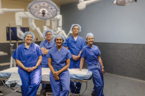 Island General Surgery and Gastroenterology surgeons in front of the da Vinci 5 robot.