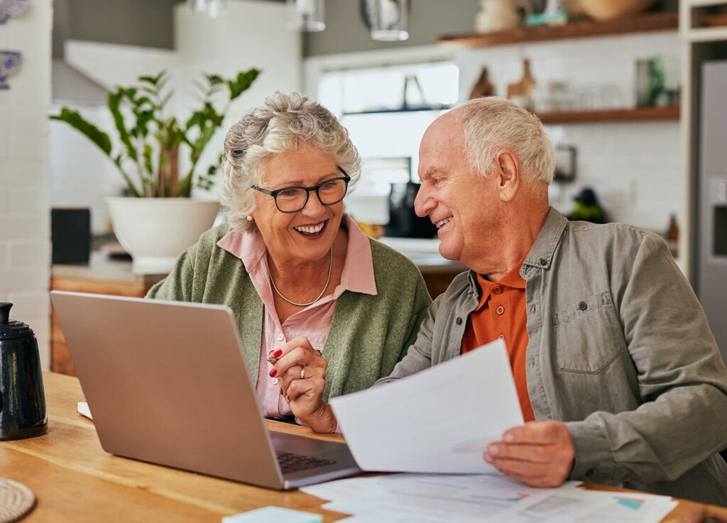 Happy couple looking at Medicare resources