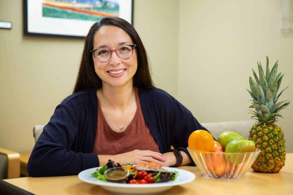 Diabetes Educator Amanda Lungren sitting at a table with healthy food in front of her.